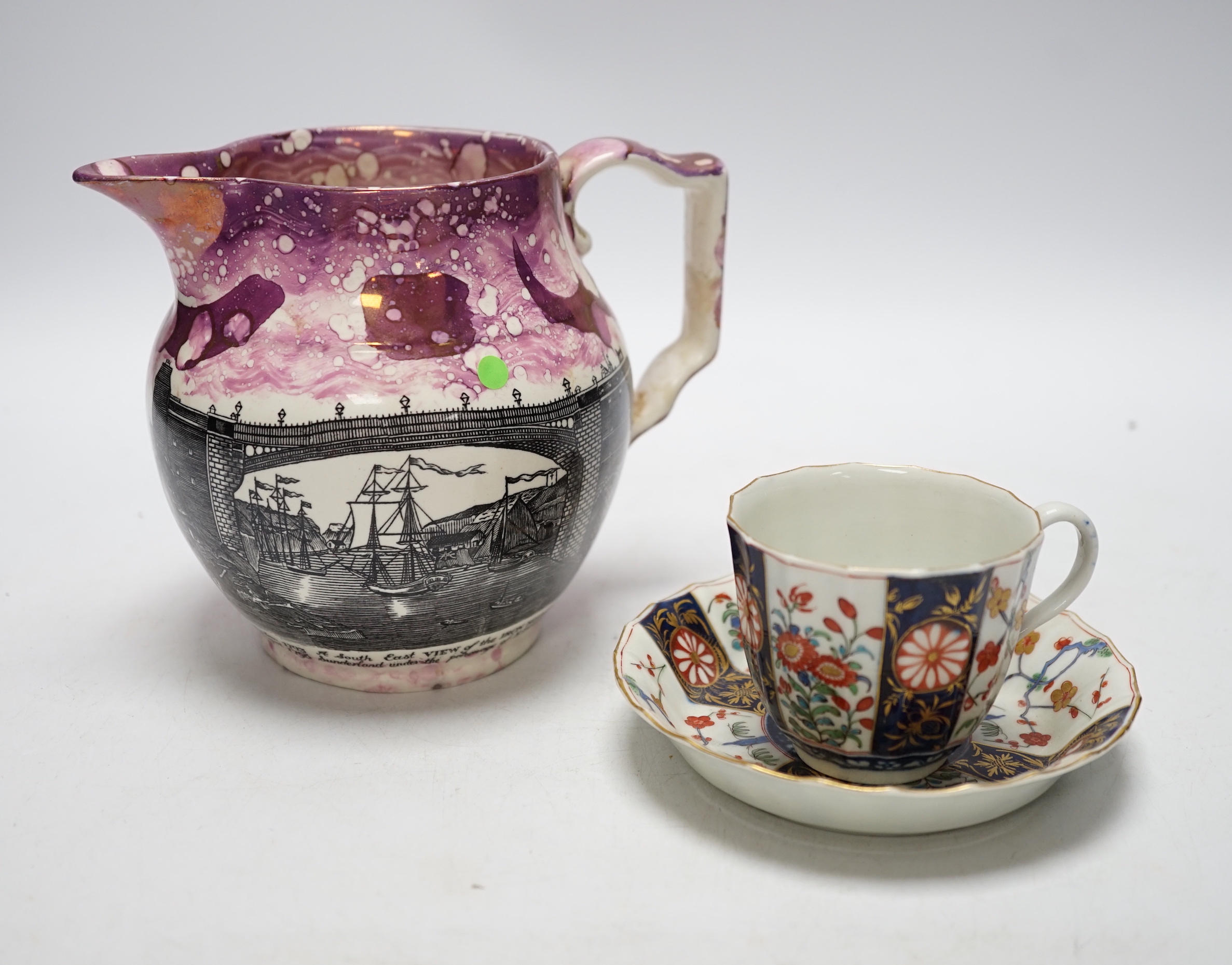 A Worcester Kakiemon pattern coffee cup and saucer, c.1780 and Gray’s Pottery pink lustre ‘’Iron Bridge Sunderland’’ jug, (3), 13cm